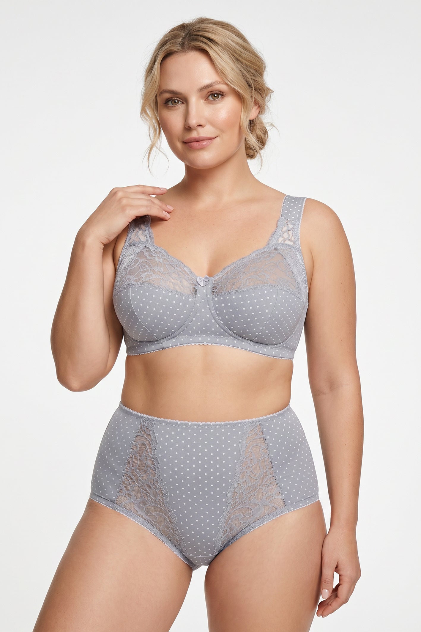 A woman modeling a light gray two-piece lingerie set with white polka dots, featuring a super comfort wireless cotton bra and matching high-waisted cotton briefs.