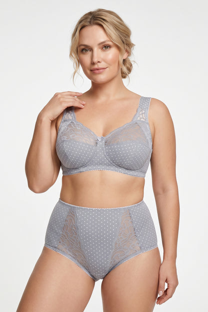 A woman modeling a light gray two-piece lingerie set with white polka dots, featuring a super comfort wireless cotton bra and matching high-waisted cotton briefs.